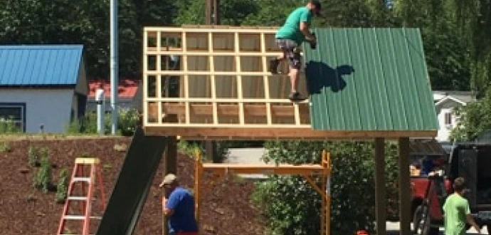 Photo of construction of a mailbox/bus stop shelter at Lamprey River Cooperative.