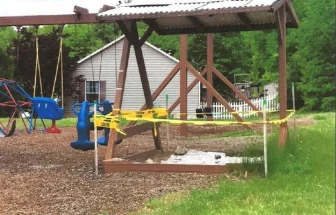 Photo of the vandalized sandbox that Pepperidge Woods considered removing.