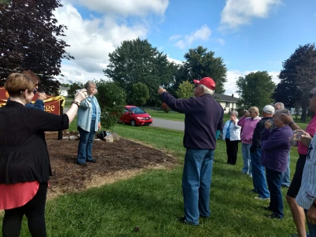 Photo of residents and new signs at community entrances.