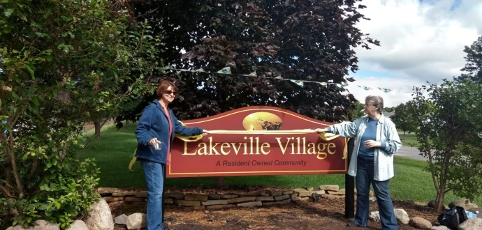 Photo of residents and new signs at community entrances.