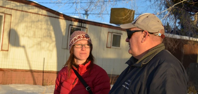 Photo of Kaia Peterson and ROC leader Charlie Schneider outside a home in Buena Vista Co-op in Missoula, Mont.
