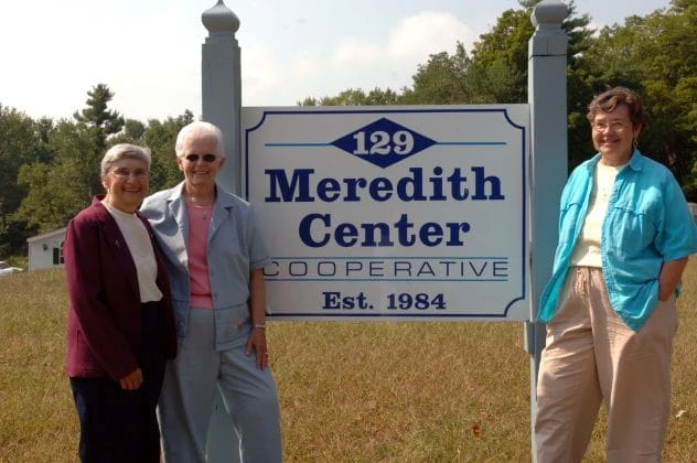 Photo showing nuns at the sign in front of Meredith Center Cooperative