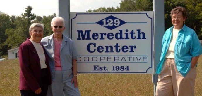 Photo showing nuns at the sign in front of Meredith Center Cooperative