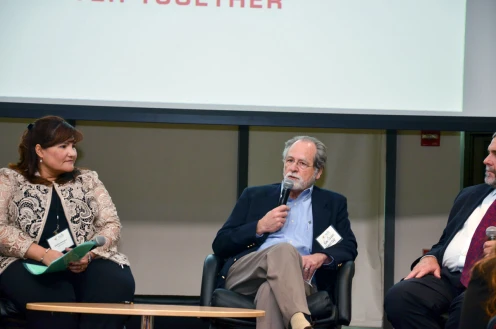 Kim Capen speaks on stage in 2018