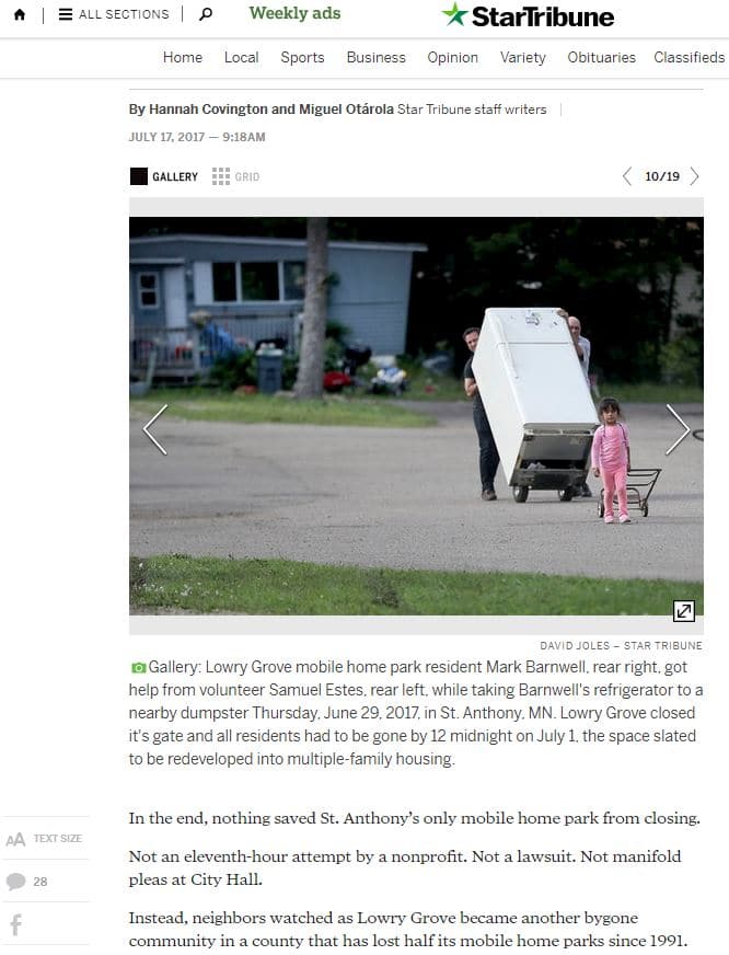 Screen shot of article with accompanying photo showing people forced to leave their community moving a refrigerator down the street.